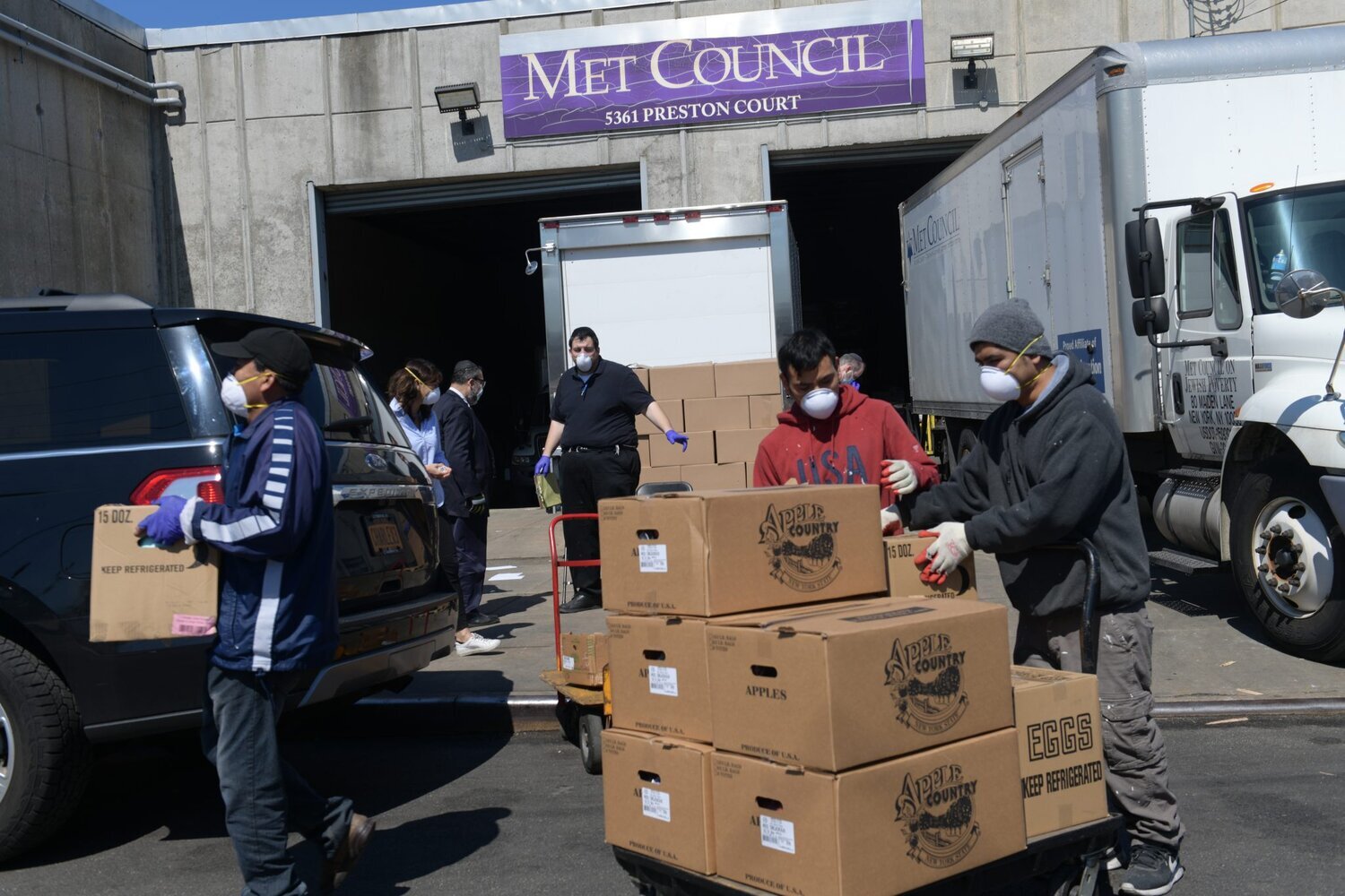 Workers prepare food for pick up. (Photo by Todd Maisel)