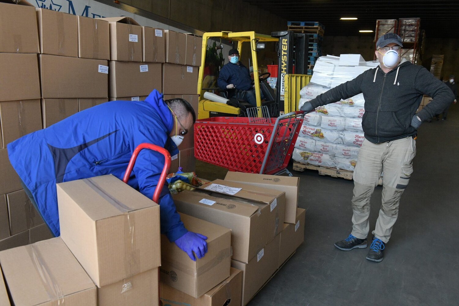 Workers prepare for deliveries and pickups of food at the Met Council warehouse. (Photo by Todd Maisel)