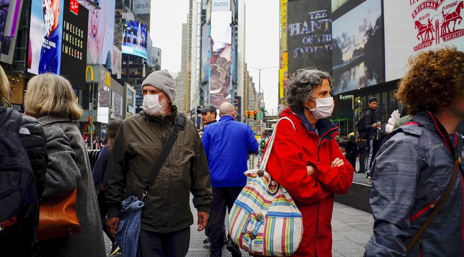 People wear face masks in Times Square in New York City after the city confirmed cases of the rapidly spreading coronavirus, March 3, 2020. (Eduardo Munoz/VIEWpress via Getty Images)