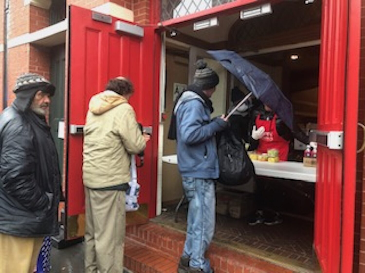 Homeless men await food from Bowery Mission.