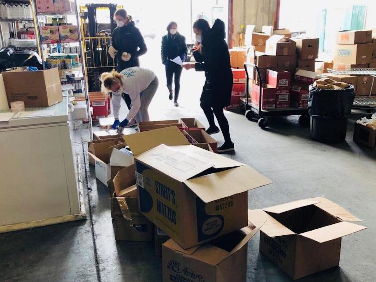 Food distribution continues at a Met Council warehouse.