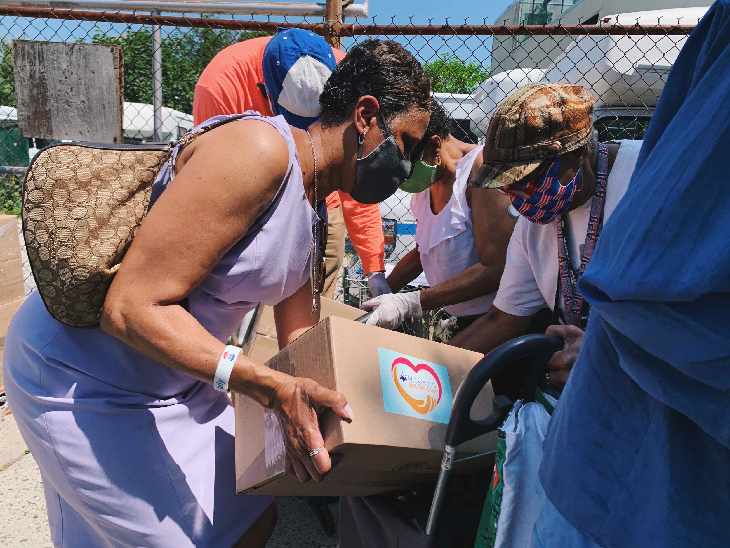 Photo courtesy of Councilwoman Adrienne Adams officeCouncilwoman Adrienne Adams in partnership with the Met Council distribute face coverings and boxes of groceries to seniors and families outside of the Allen Community Rockaway Senior Center locate…