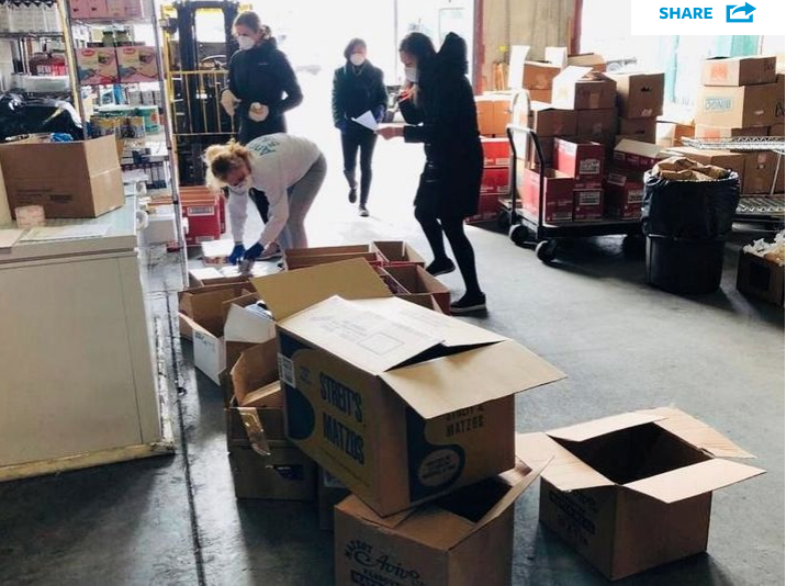Met Council Volunteers packing boxes of Passover food.
