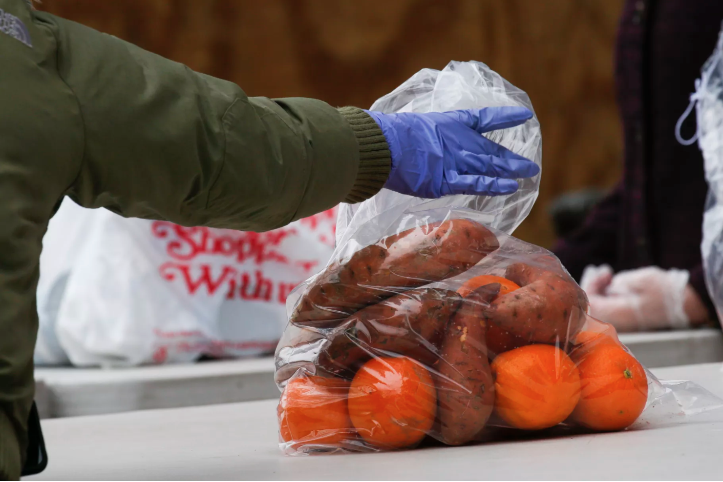 A volunteer from City Harvest distributing food on March 28, 2020 Photo by KENA BETANCUR/AFP via Getty Images