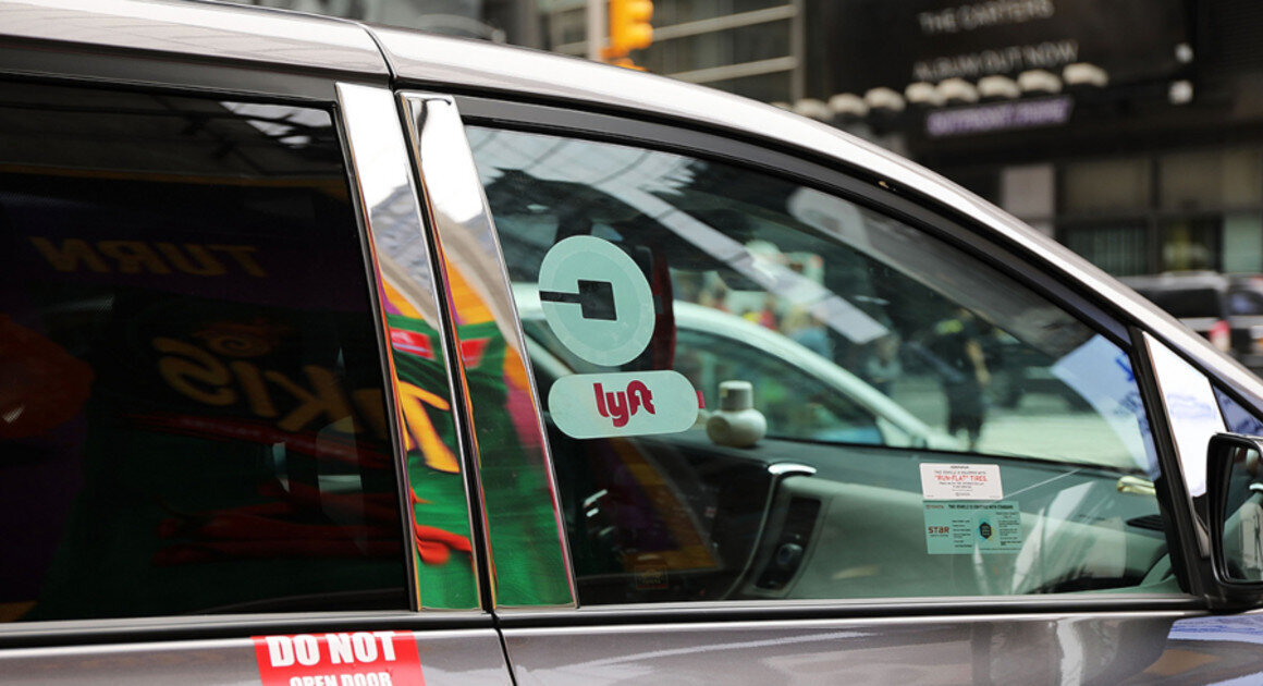 A ride-hailing vehicle with stickers for Uber and Lyft | Spencer Platt/Getty Images