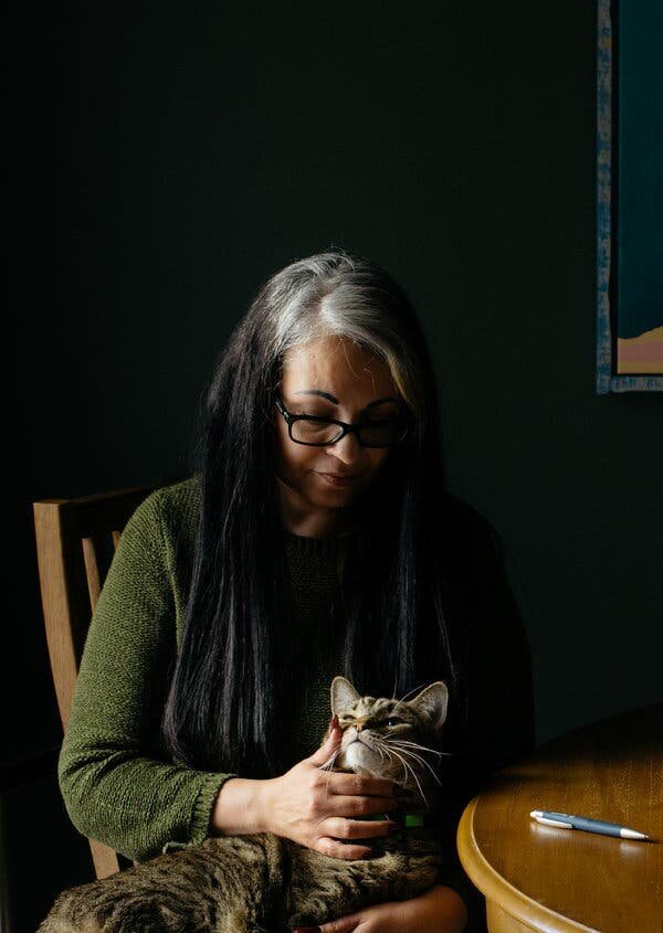 Ana Helfer, at home with one of her cats, Marley, survived years of emotional and physical abuse from her husbandCredit Alex Flynn for The New York Times