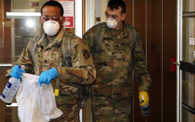 New York Army National Guard troops clean New Rochelle City Hall on Saturday, March 14, 2020 as part of the state