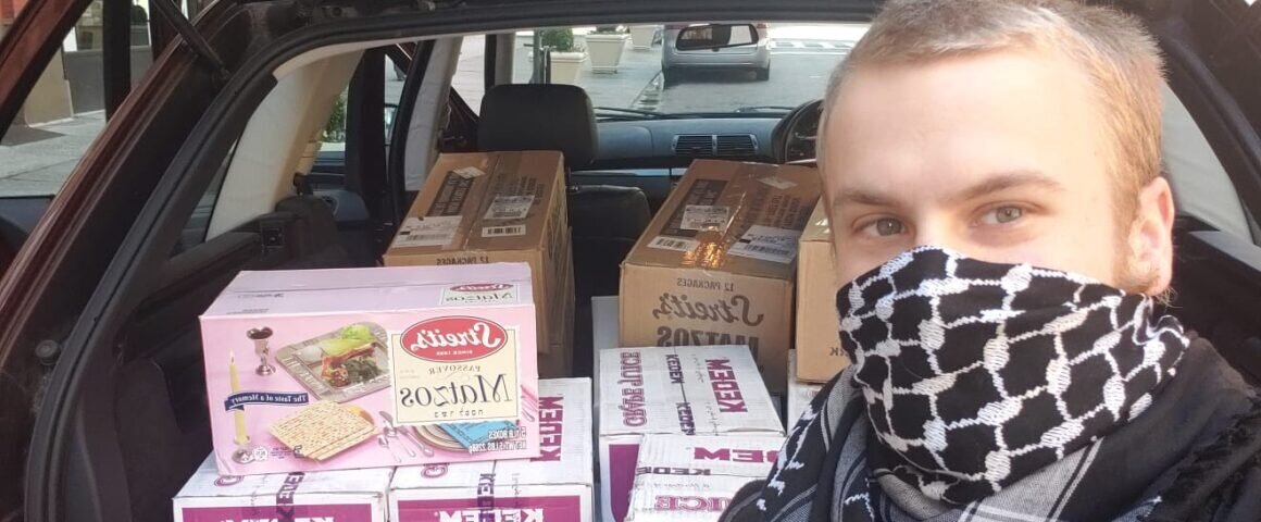 Photo: Student Paul Horowitz pictured with a transport of matzah, grape juice and siddurim.