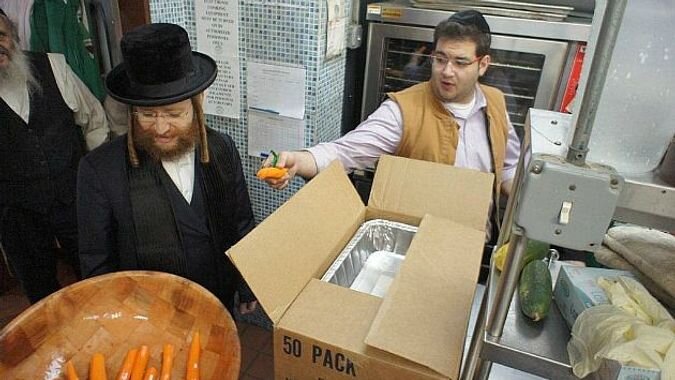 Helping Hand: Volunteers from Masbia Soup Kitchens/Met-Council and Chaverim prepare emergency food for seniors affected by Sandy at the Park Slope Armory in Brooklyn.